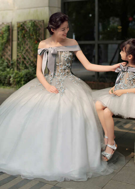 Abiti da sposa mamma e figlia coordinati colore grigio fatto in tulle e raso scollo a spalle scoperte decorazioni di pizzo applicato e fiocco