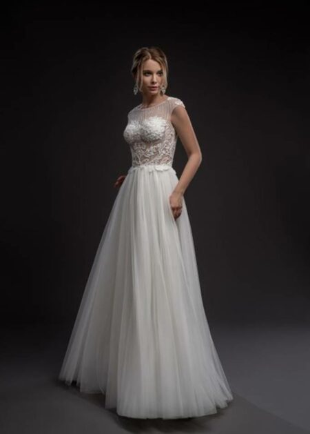 Abito da sposa tendenze 2022 fatto in raso, tulle e decorazioni di pizzo con trasparenze sul corpetto